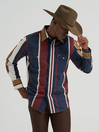 Wrangler men’s Retro Brushpopper long sleeve snap shirt featuring navy, burgundy, gold and cream vertical stripes, pearl snaps, Western yokes, and dual chest pockets.