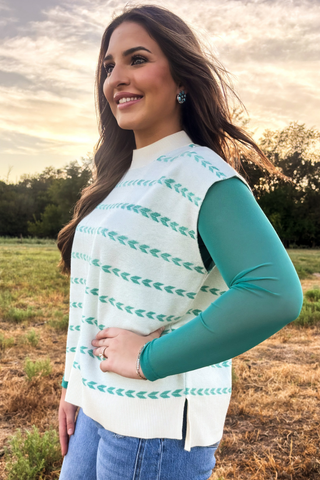 Sterling Kreek turquoise mesh top layered under a western sweater vest