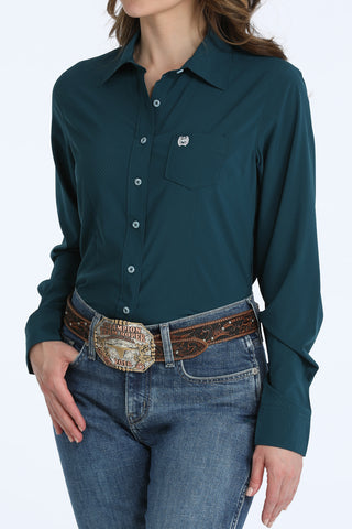 Cinch women’s teal ArenaFlex performance western shirt with breathable mesh fabric, long sleeves, chest pocket, and stretch comfort.