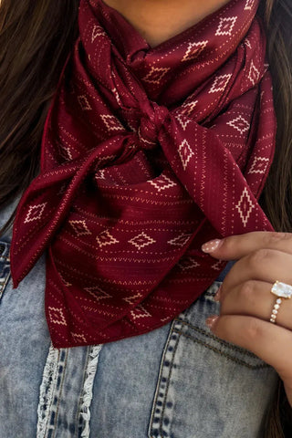 Sterling Kreek Crimson Dust red wild rag with cream geometric Western print tied around neck